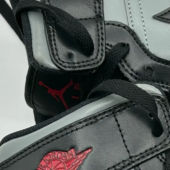 Black and Gray Sneakers with Red Accents